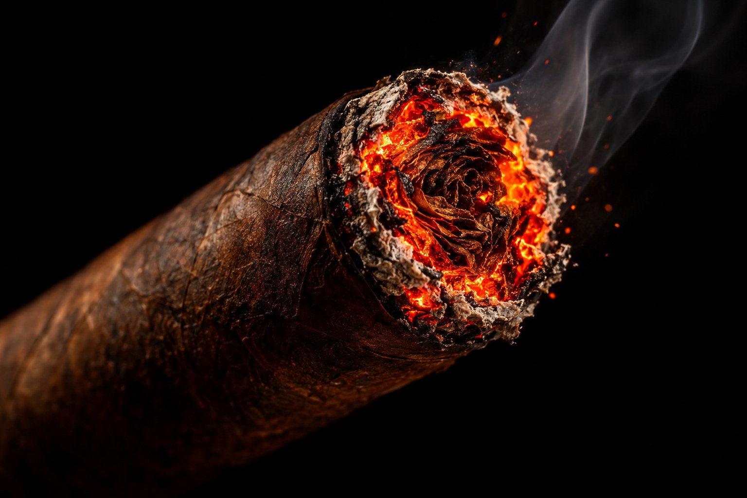 The glowing lit foot of a cigar in close detail.